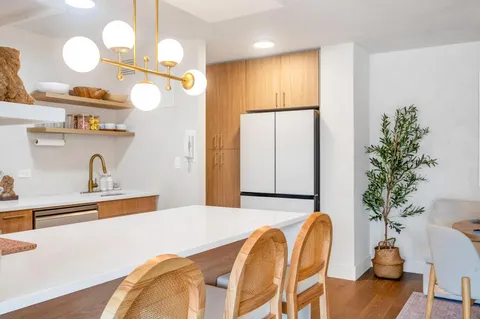a dining room with furniture and wooden floor