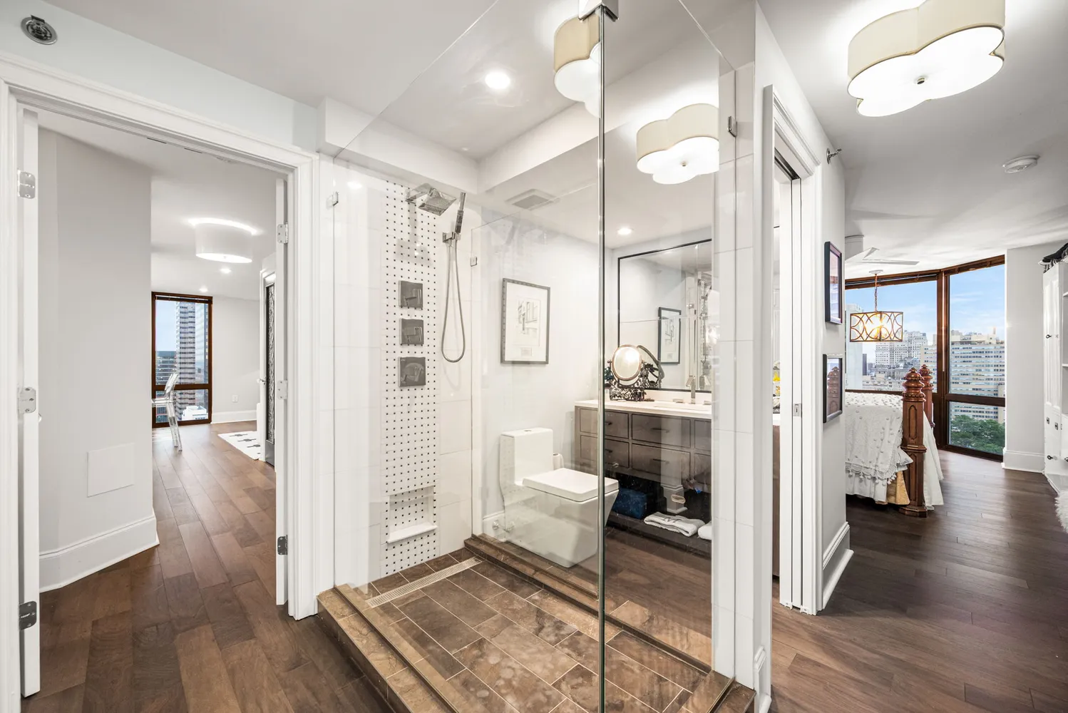 a bathroom with a glass door shower and a sink