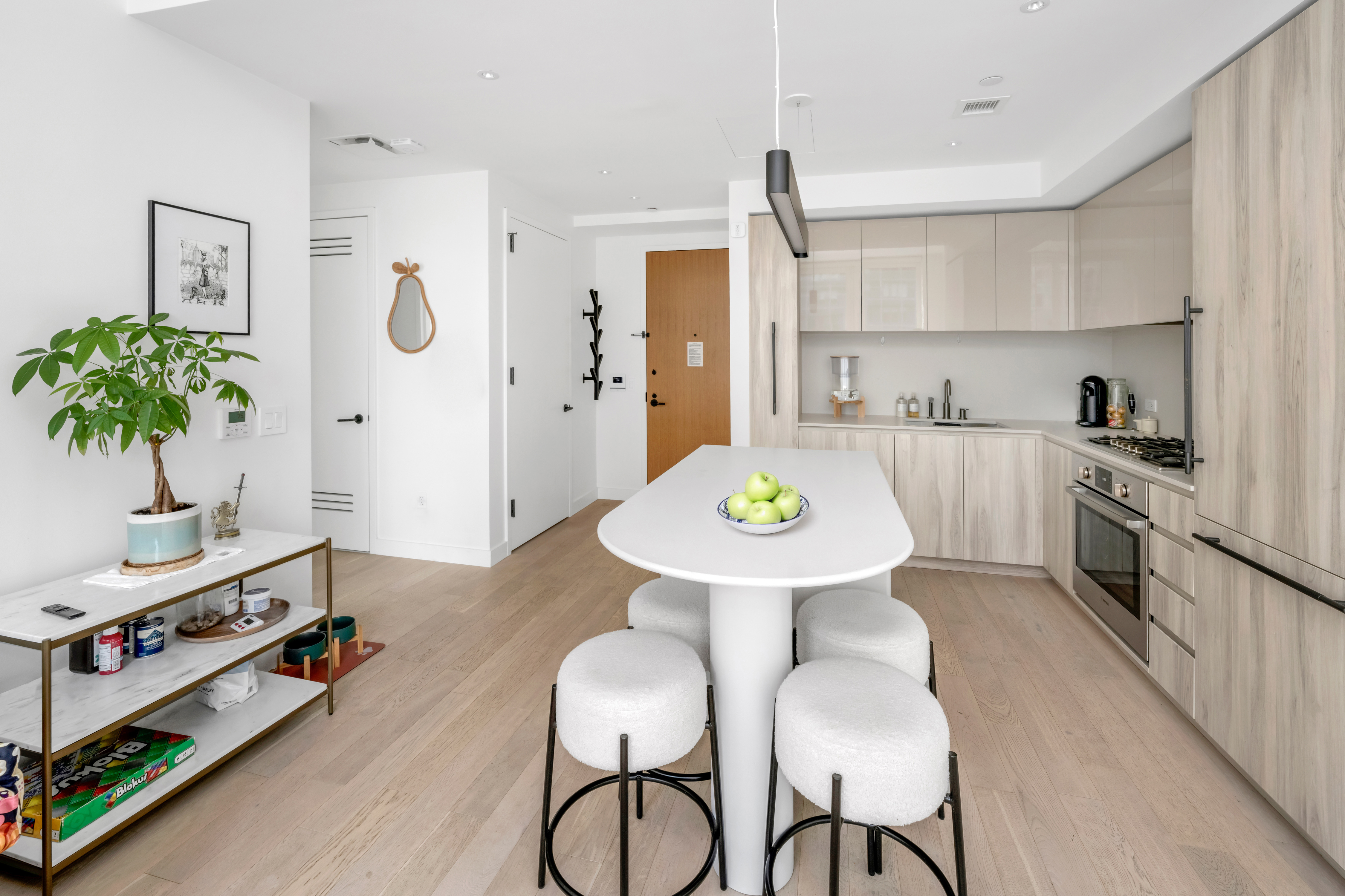 1 West 60th Street, Unit 16C Manhattan, NY 10019 - Photo 2 of 8 a kitchen with a table and chairs in it