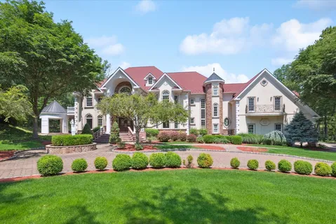 an aerial view of a house with a swimming pool and garden