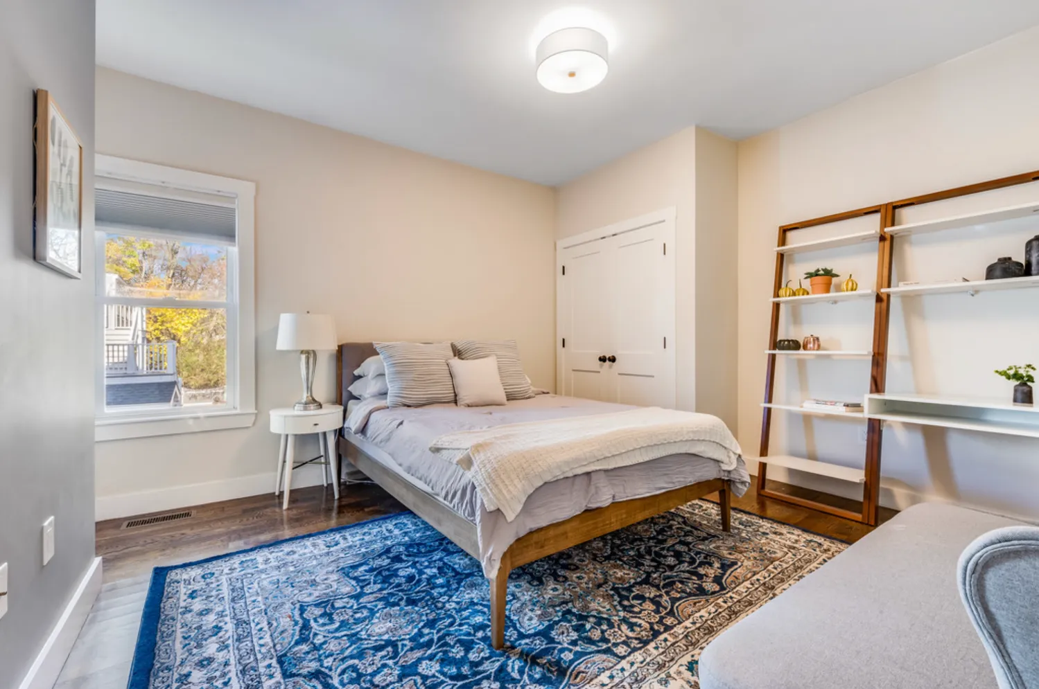 a bedroom with a bed and wooden floor