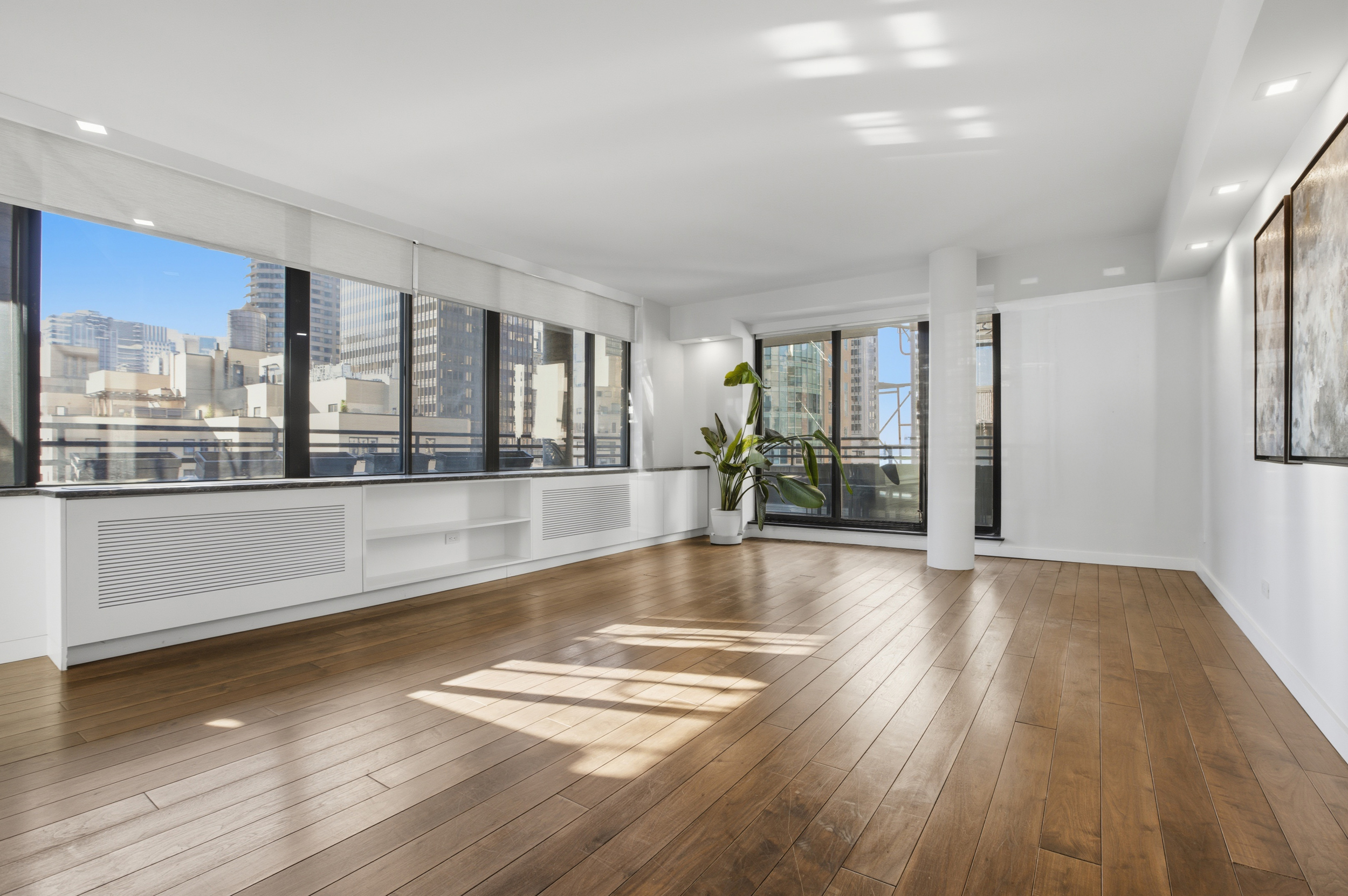 309 East 49th Street, Unit 21A Manhattan, NY 10017 - Photo 2 of 18 a view of an empty room with wooden floor and a window