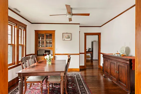a view of a dining room with furniture and window