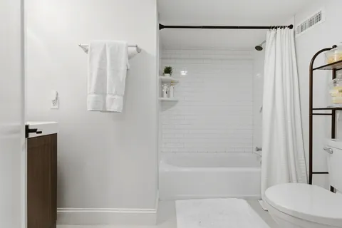 a bathroom with a shower a bathtub and a shower