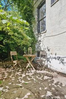 a view of a chairs and table in a backyard