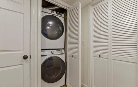 a view of a hallway with washer and dryer