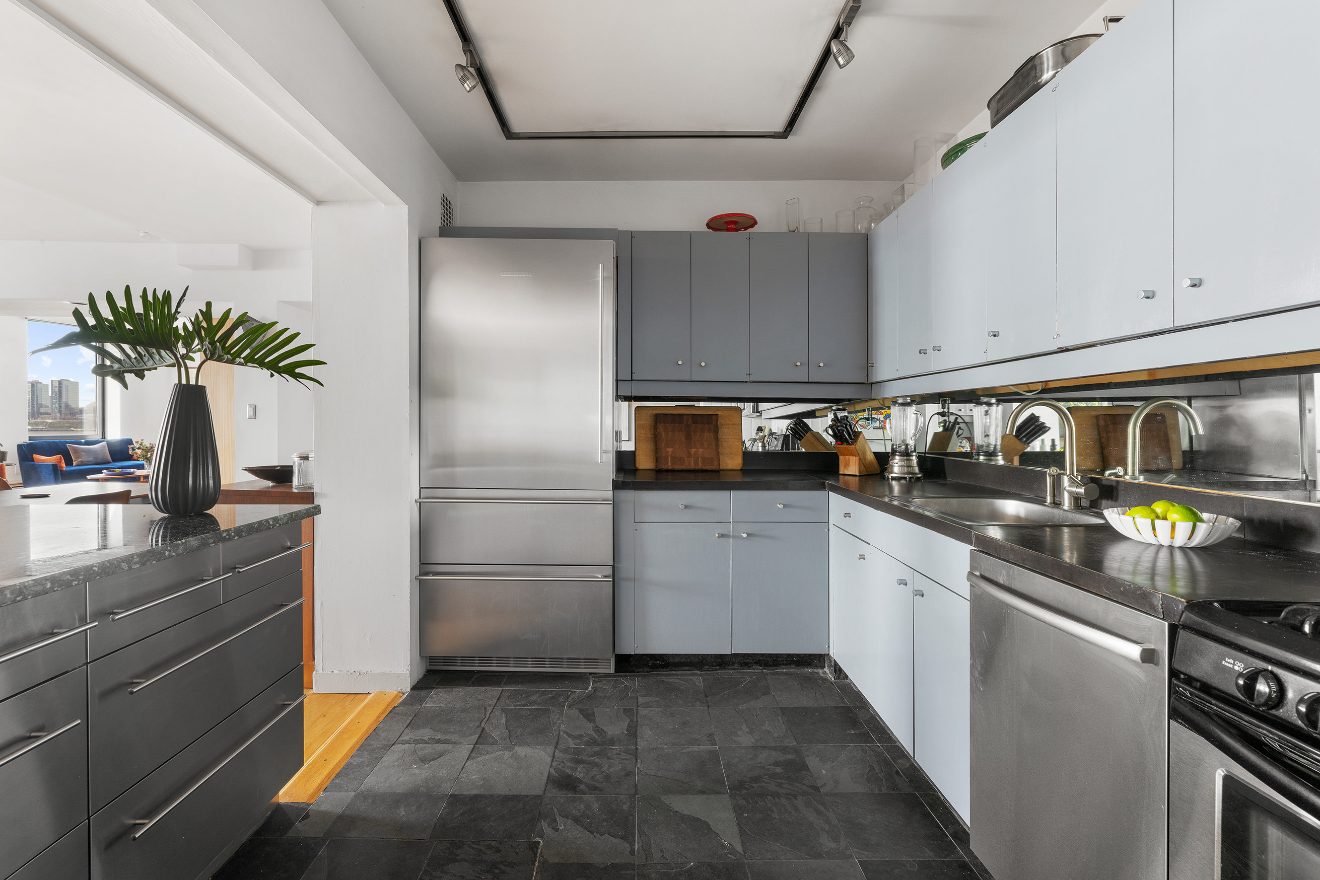166 Bank Street, Unit 6B Manhattan, NY 10014 - Photo 6 of 16 a kitchen with a sink and refrigerator