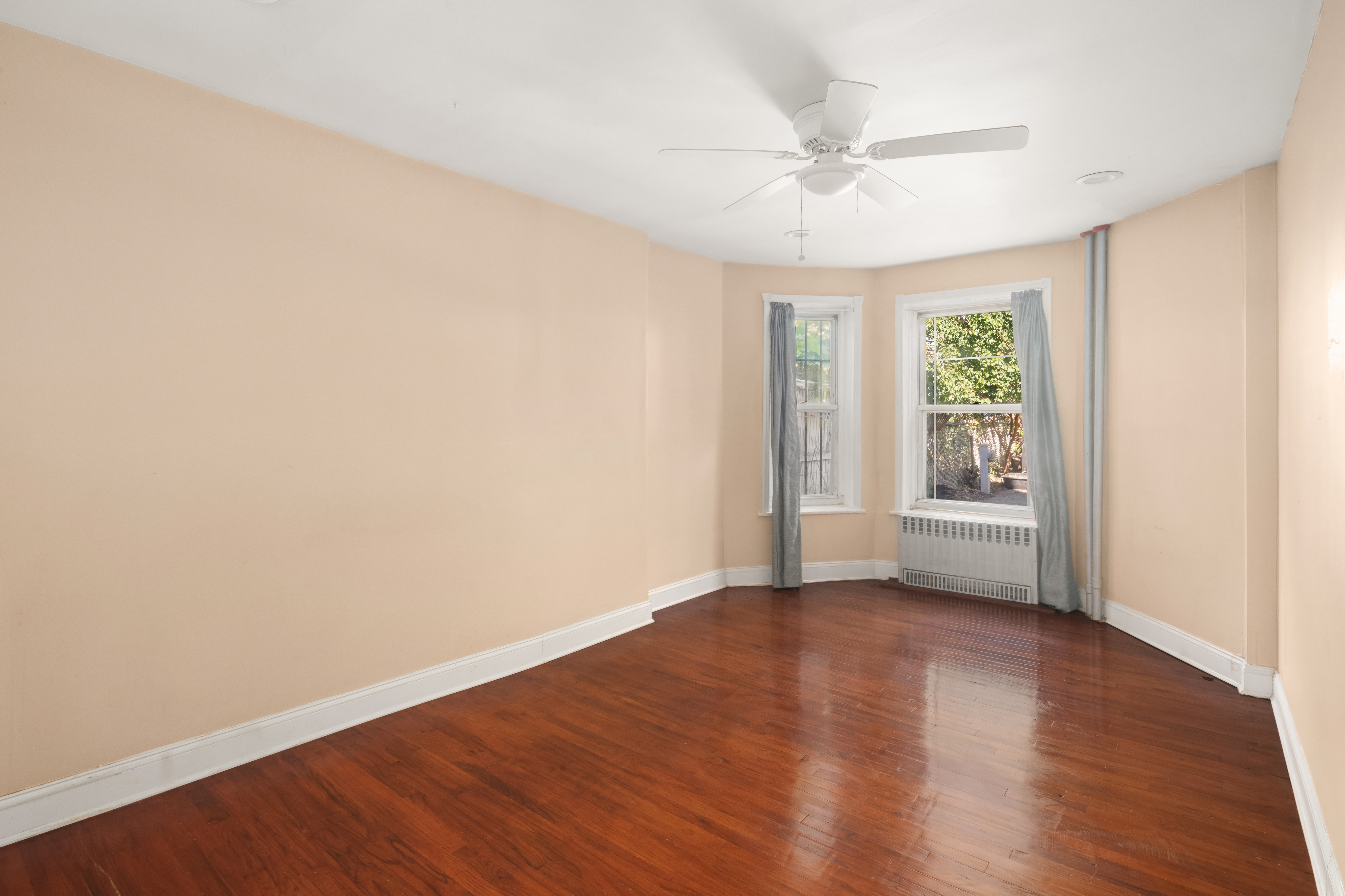 1135 Park Place Brooklyn, NY 11213 - Photo 16 of 18 wooden floor in an empty room with a window