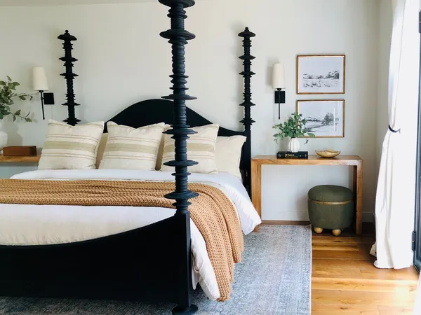 a bedroom with a bed and a chair