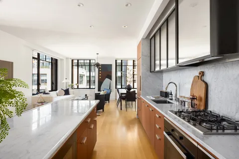 a kitchen with stainless steel appliances granite countertop a lot of counter space and a sink