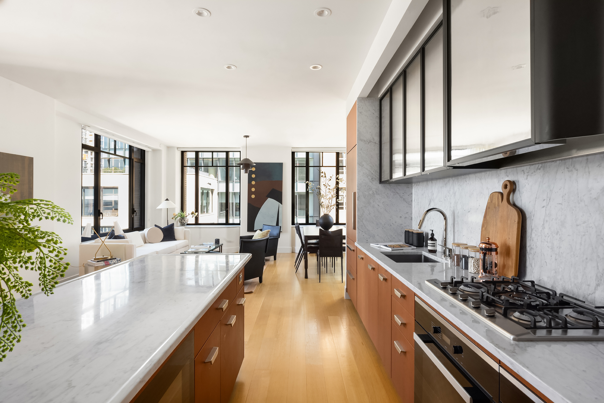 110 Charlton Street, Unit 17E Manhattan, NY 10014 - Photo 12 of 20 a kitchen with stainless steel appliances granite countertop a lot of counter space and a sink