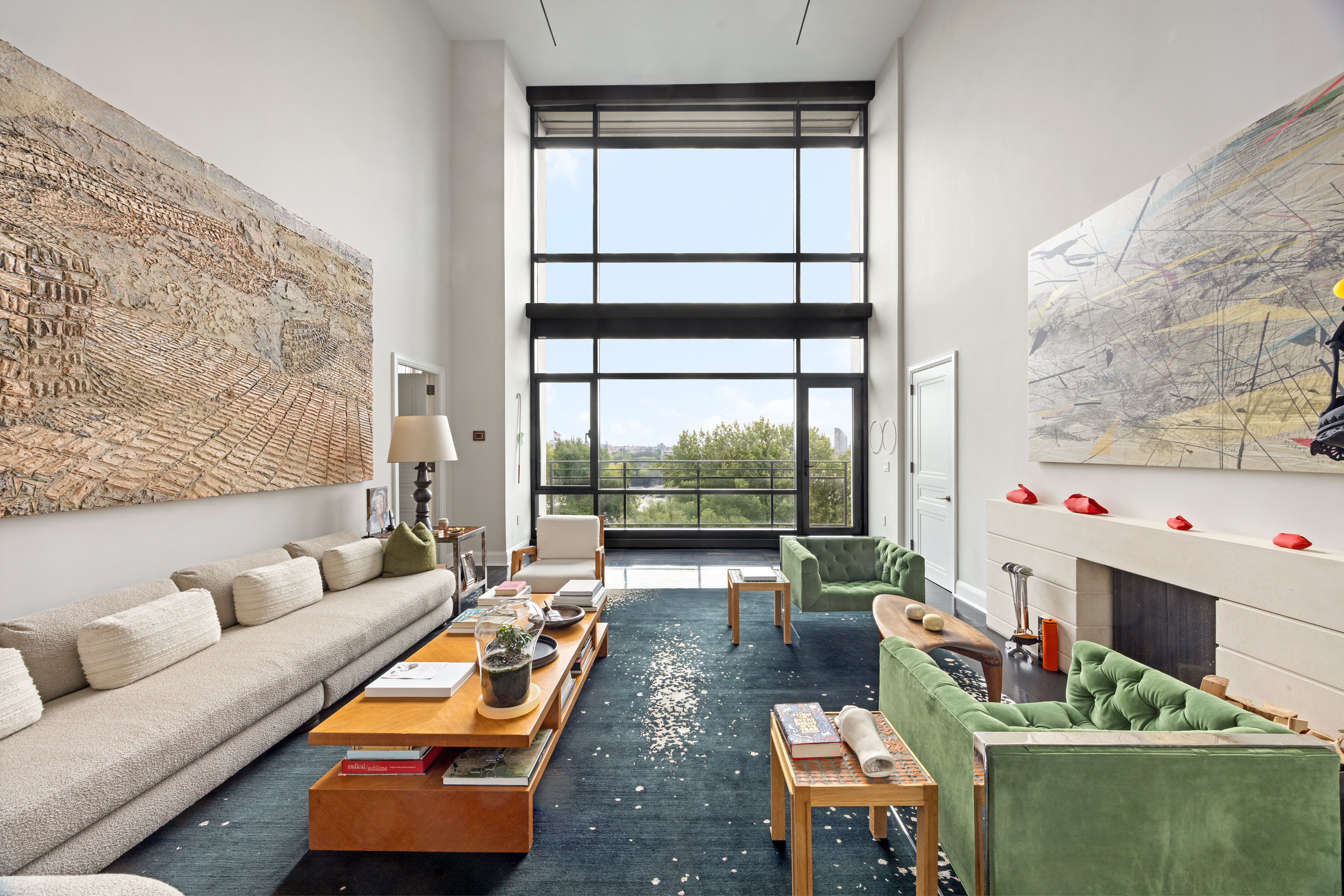 a living room with furniture and a floor to ceiling window