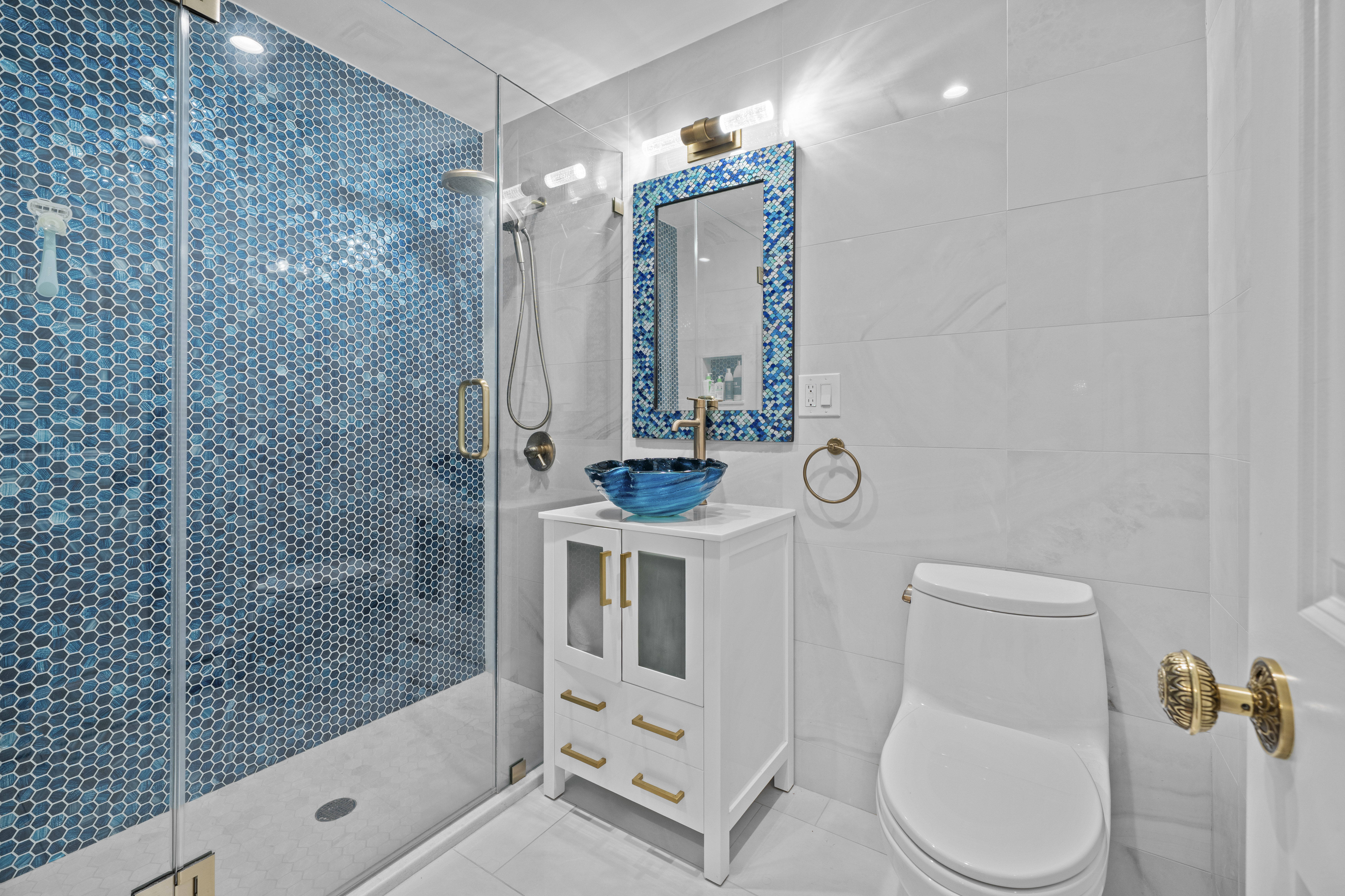 2253 East 64th Street Brooklyn, NY 11234 - Photo 26 of 45 a bathroom with a toilet sink and shower