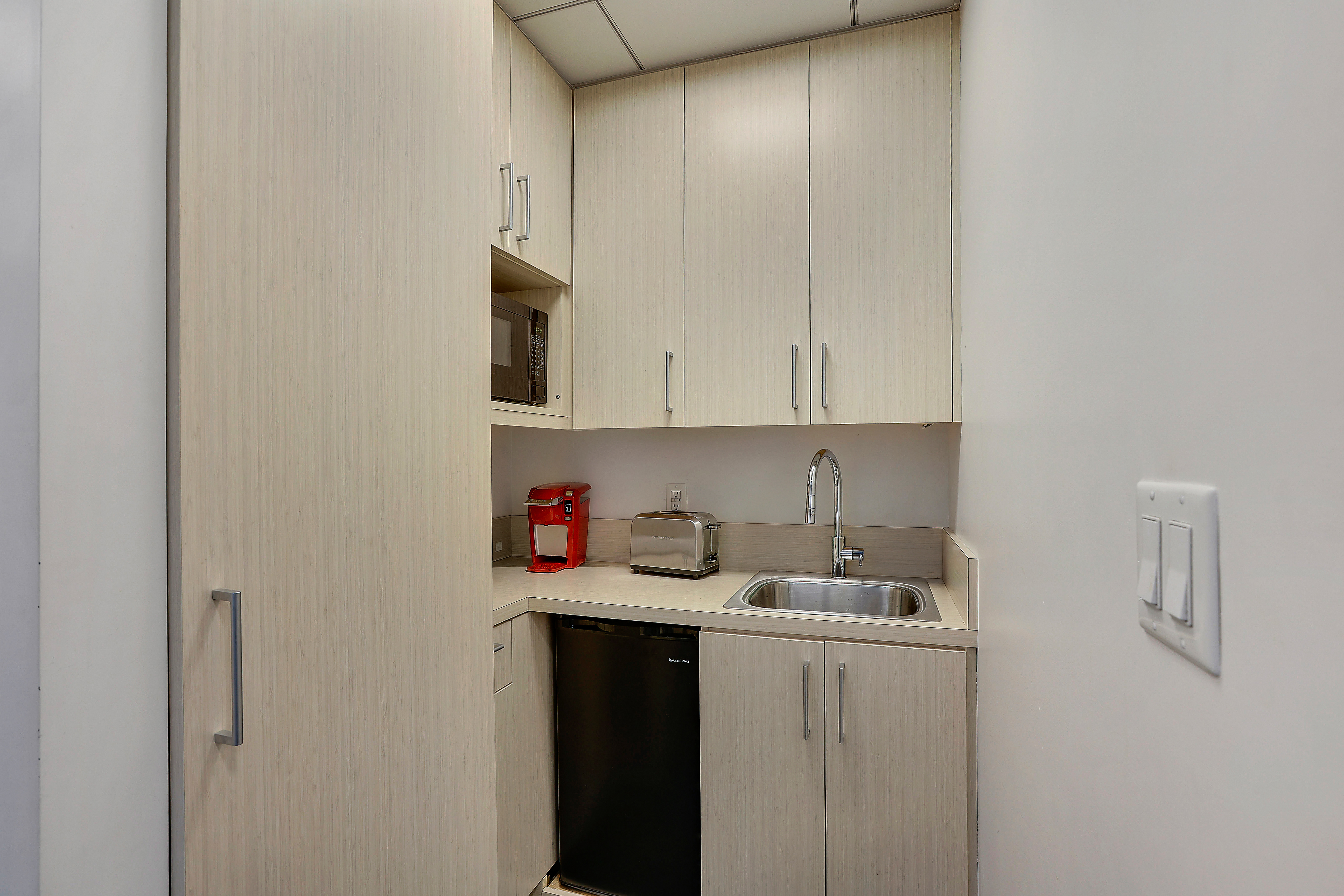 50 West 47th Street Manhattan, NY 10036 - Photo 5 of 8 a kitchen with a sink and cabinets