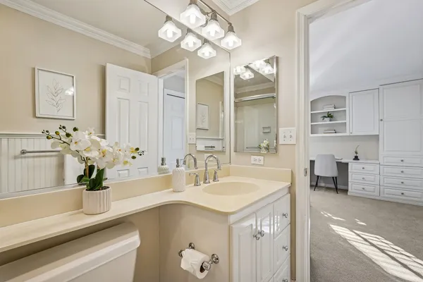 a bathroom with a sink a large mirror and a bathtub