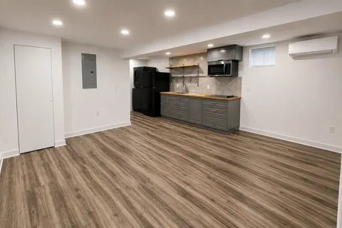 a view of a hallway with wooden floor and staircase