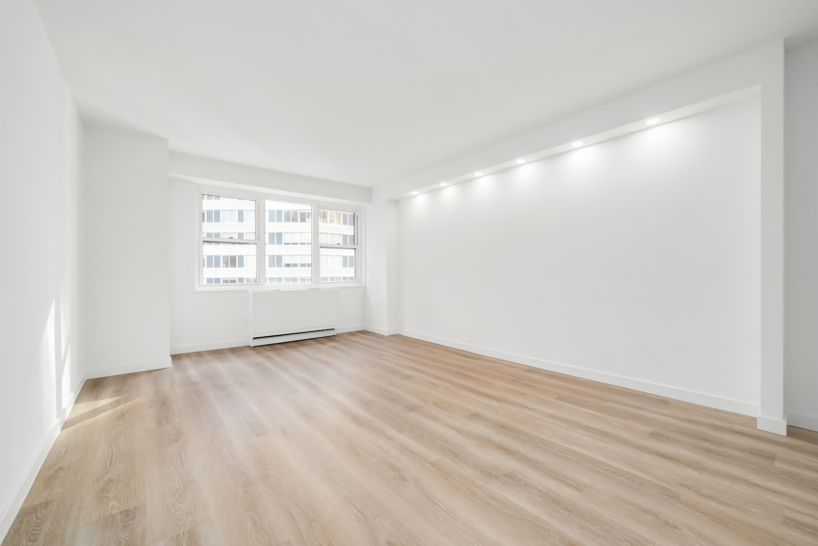 400 East 54th Street, Unit 8A Manhattan, NY 10022 - Photo 2 of 20 wooden floor in an empty room with a window
