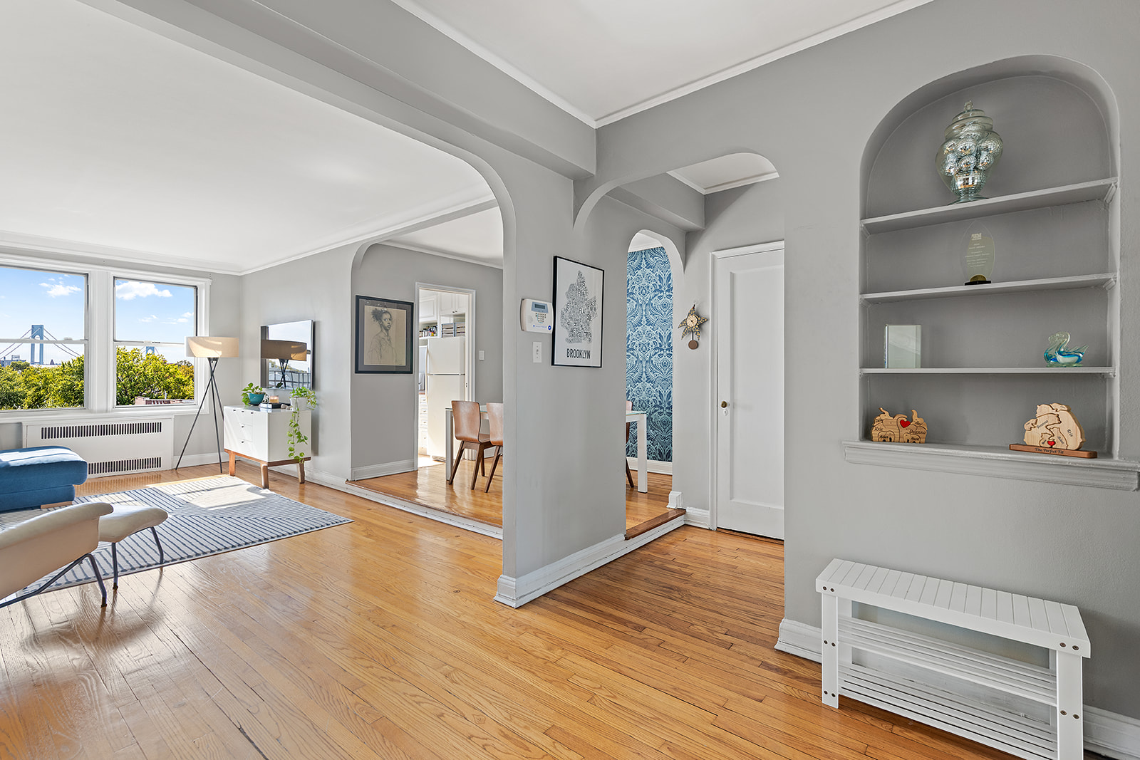 601 79th Street, Unit E12 Brooklyn, NY 11209 - Photo 2 of 8 a living room with furniture and a wooden floor