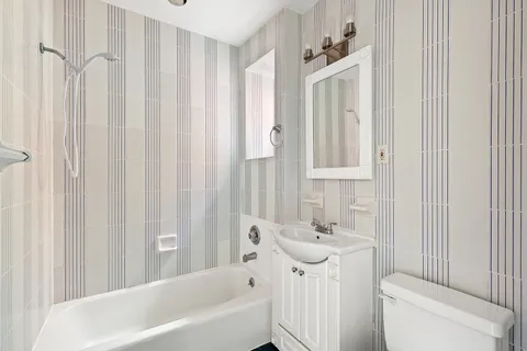 a bathroom with a sink a toilet and shower curtain