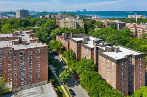 an aerial view of multiple houses with a yard