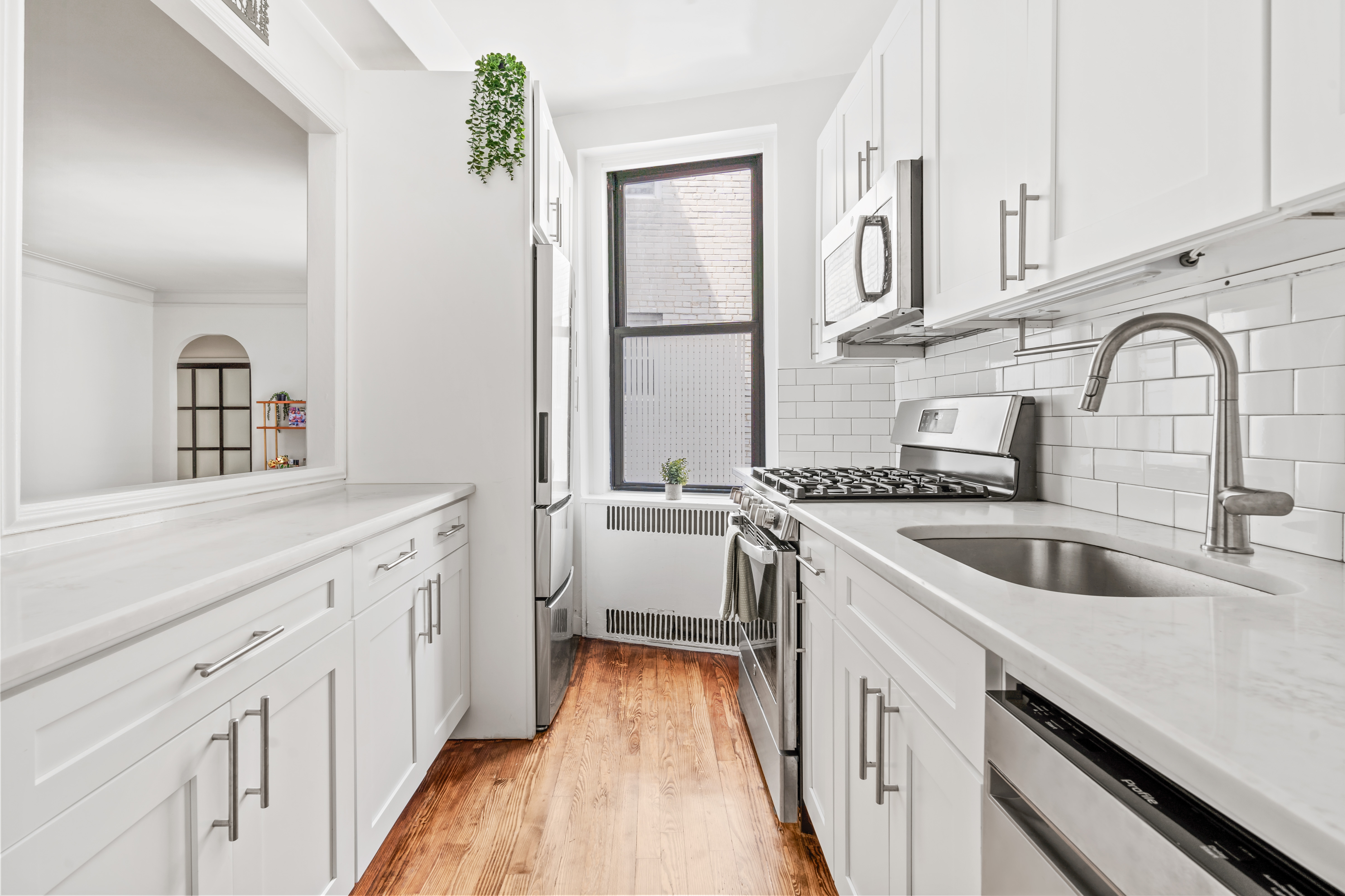 225 West 25th Street, Unit 5D Manhattan, NY 10001 - Photo 4 of 16 a view of a kitchen with sink and washing machine