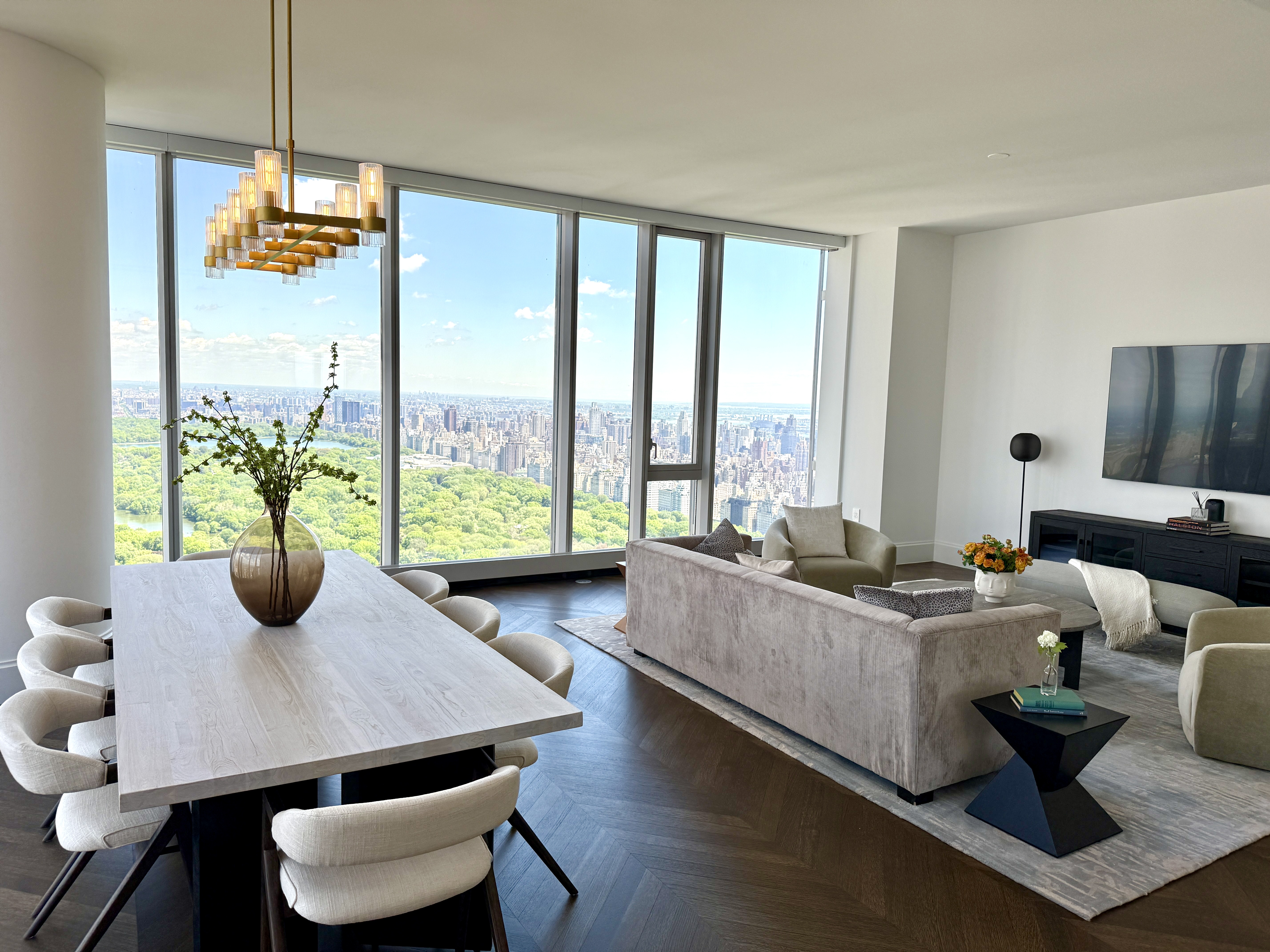 217 West 57th Street, Unit 60W Manhattan, NY 10019 - Photo 1 of 27 a living room with furniture and a large window