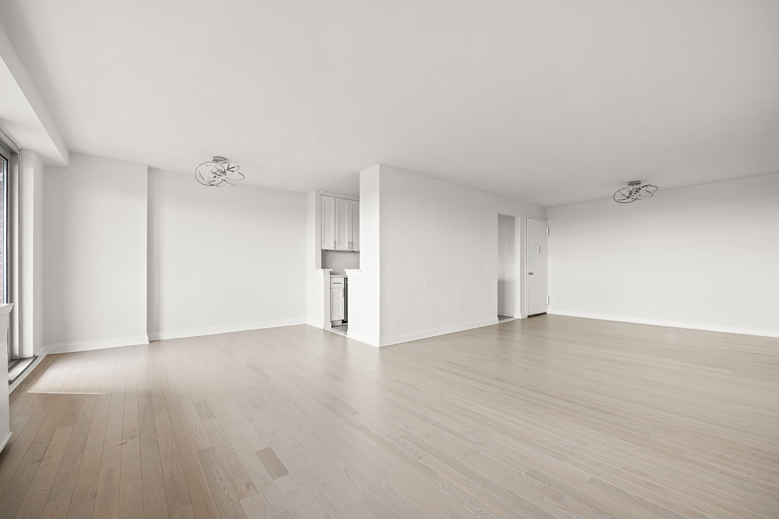 135 Ocean Parkway, Unit 16N Brooklyn, NY 11218 - Photo 6 of 16 an empty room with wooden floor and windows