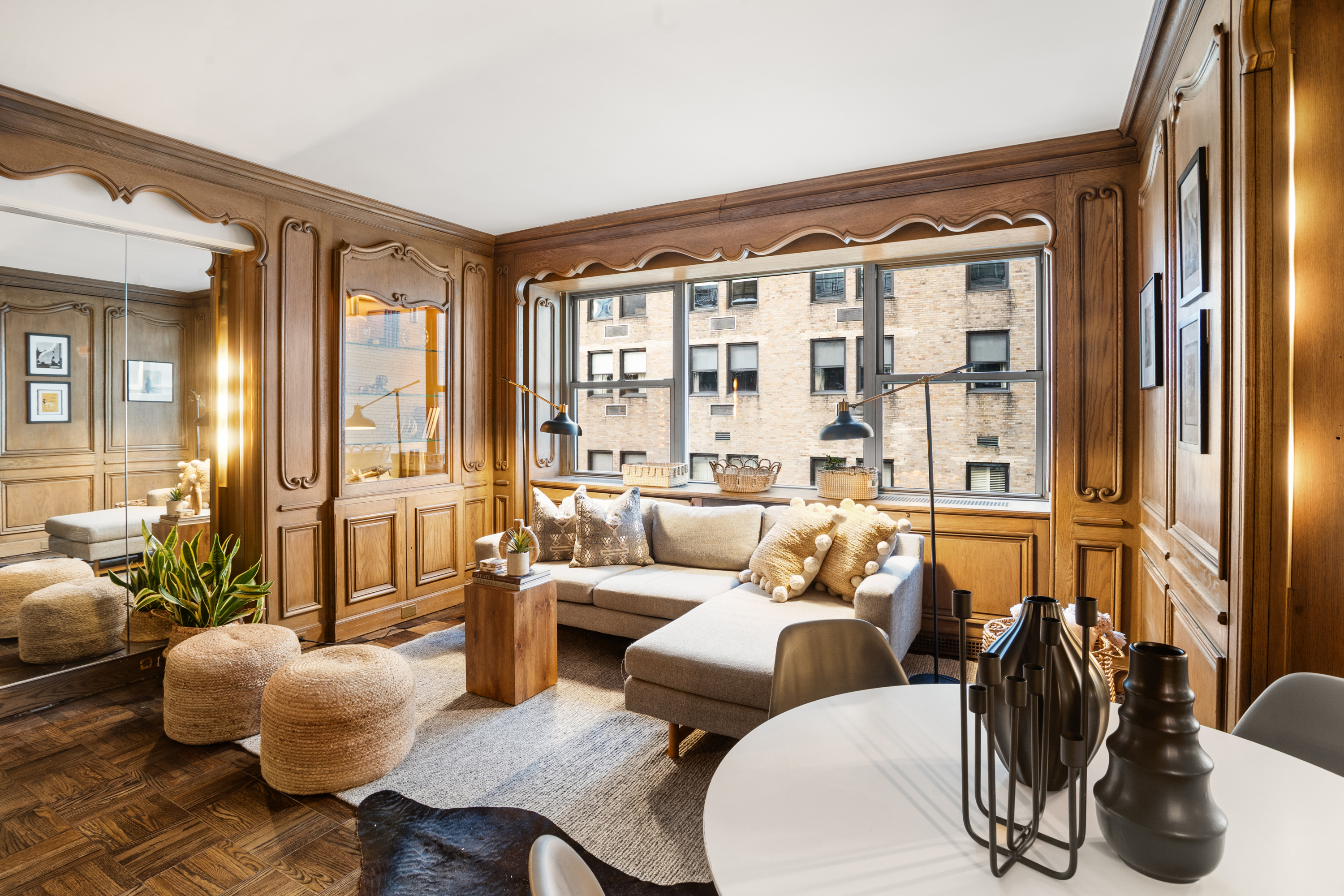 110 East 57th Street, Unit 16B Manhattan, NY 10022 - Photo 6 of 15 a living room with furniture and a large window