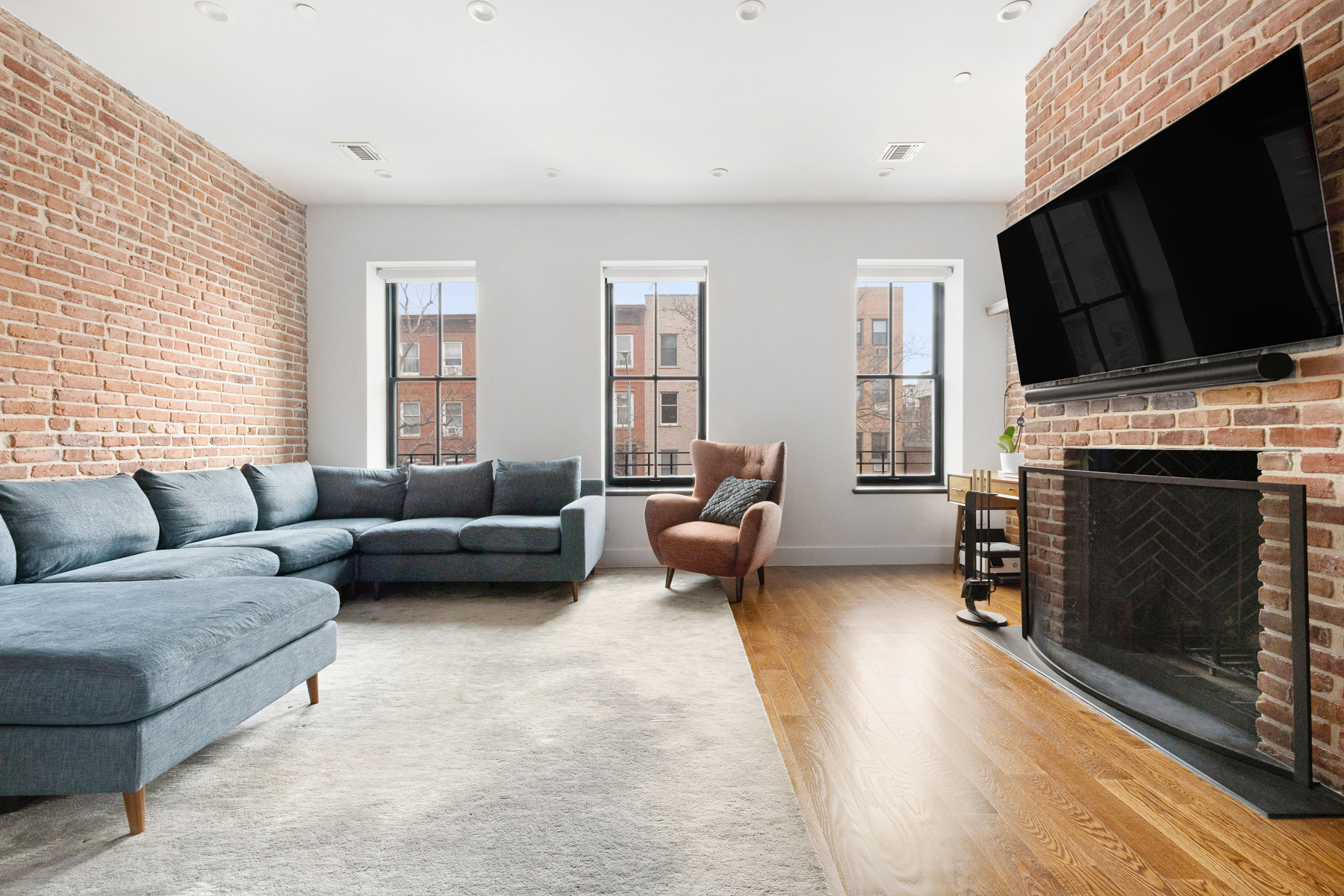 110 Summit Street, Unit 2 Brooklyn, NY 11231 - Photo 3 of 13 a living room with furniture a fireplace and a flat screen tv