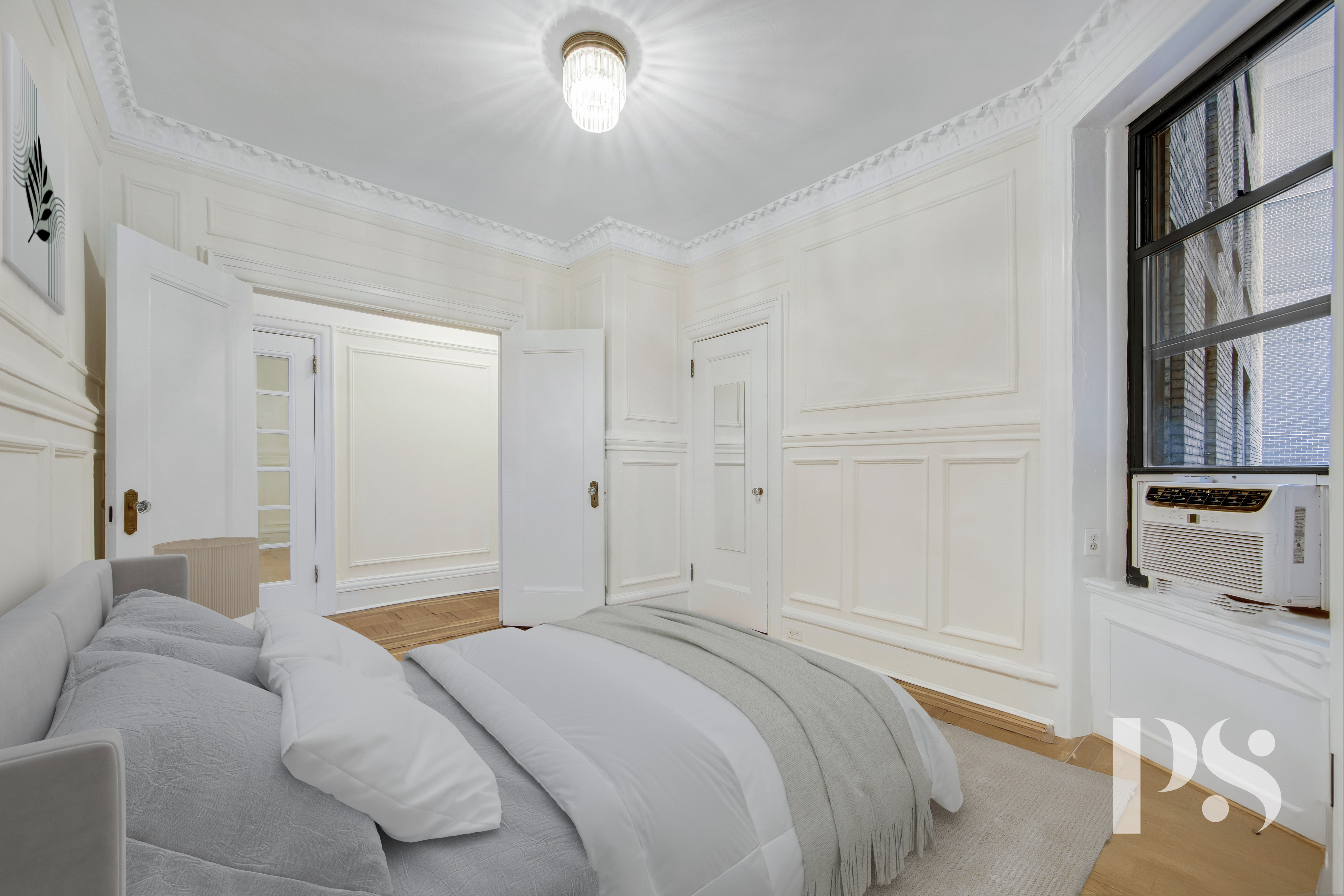 200 West 54th Street, Unit 6J Manhattan, NY 10019 - Photo 11 of 12 a bedroom with a bed and a book shelf