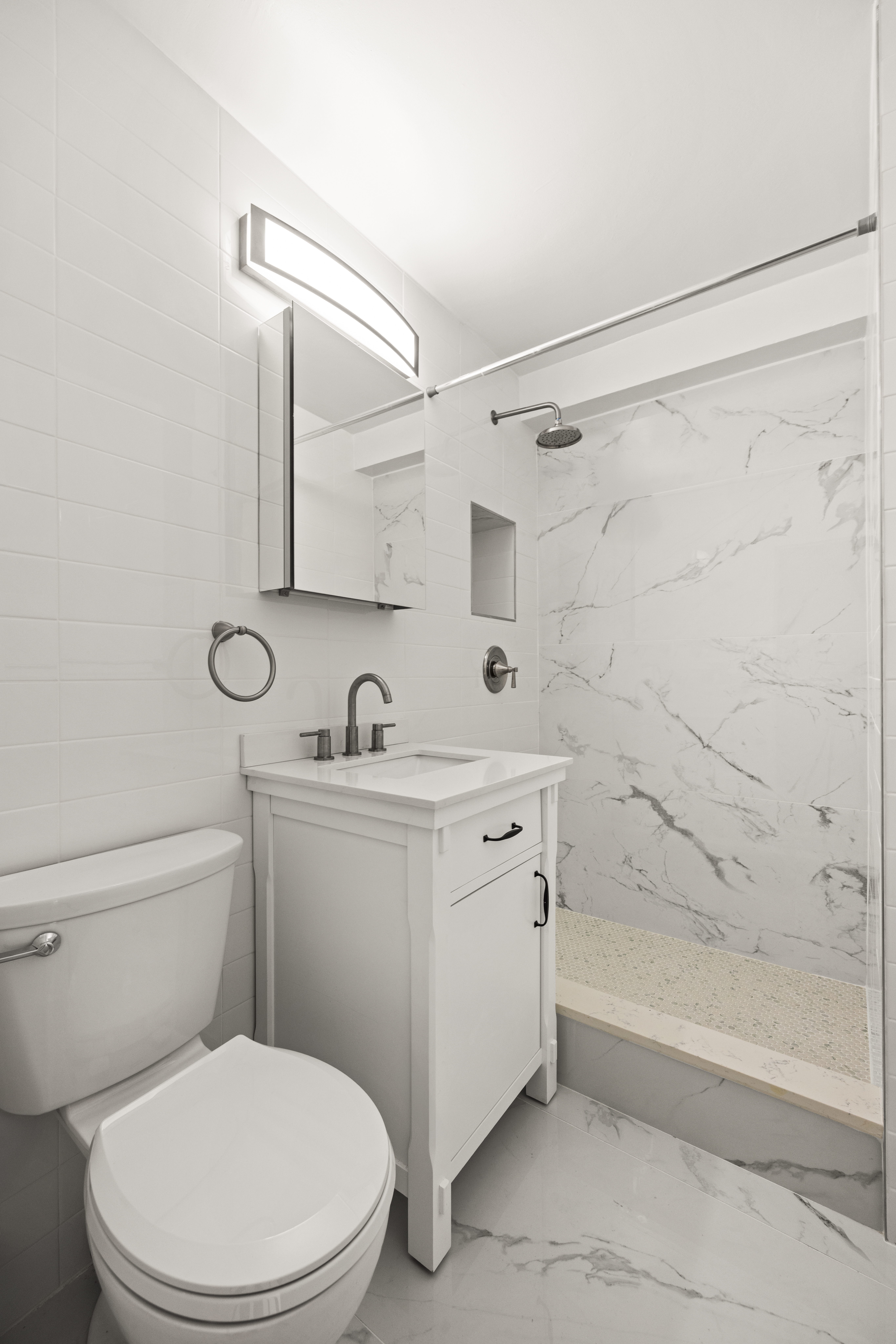 135 Ocean Parkway, Unit 16N Brooklyn, NY 11218 - Photo 11 of 16 a bathroom with a sink a toilet and shower