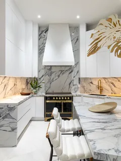 a kitchen with kitchen island granite countertop a stove and a sink