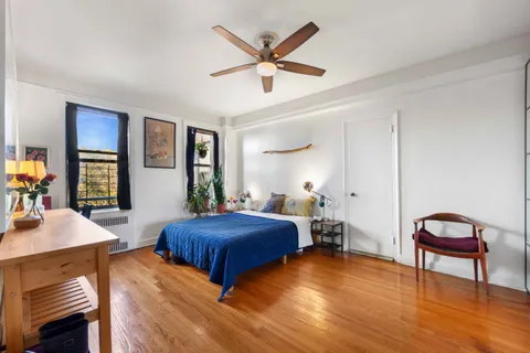 a bedroom with a bed and a table in it