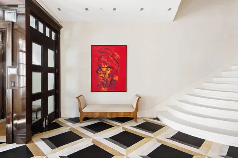a living room with furniture and a book shelf