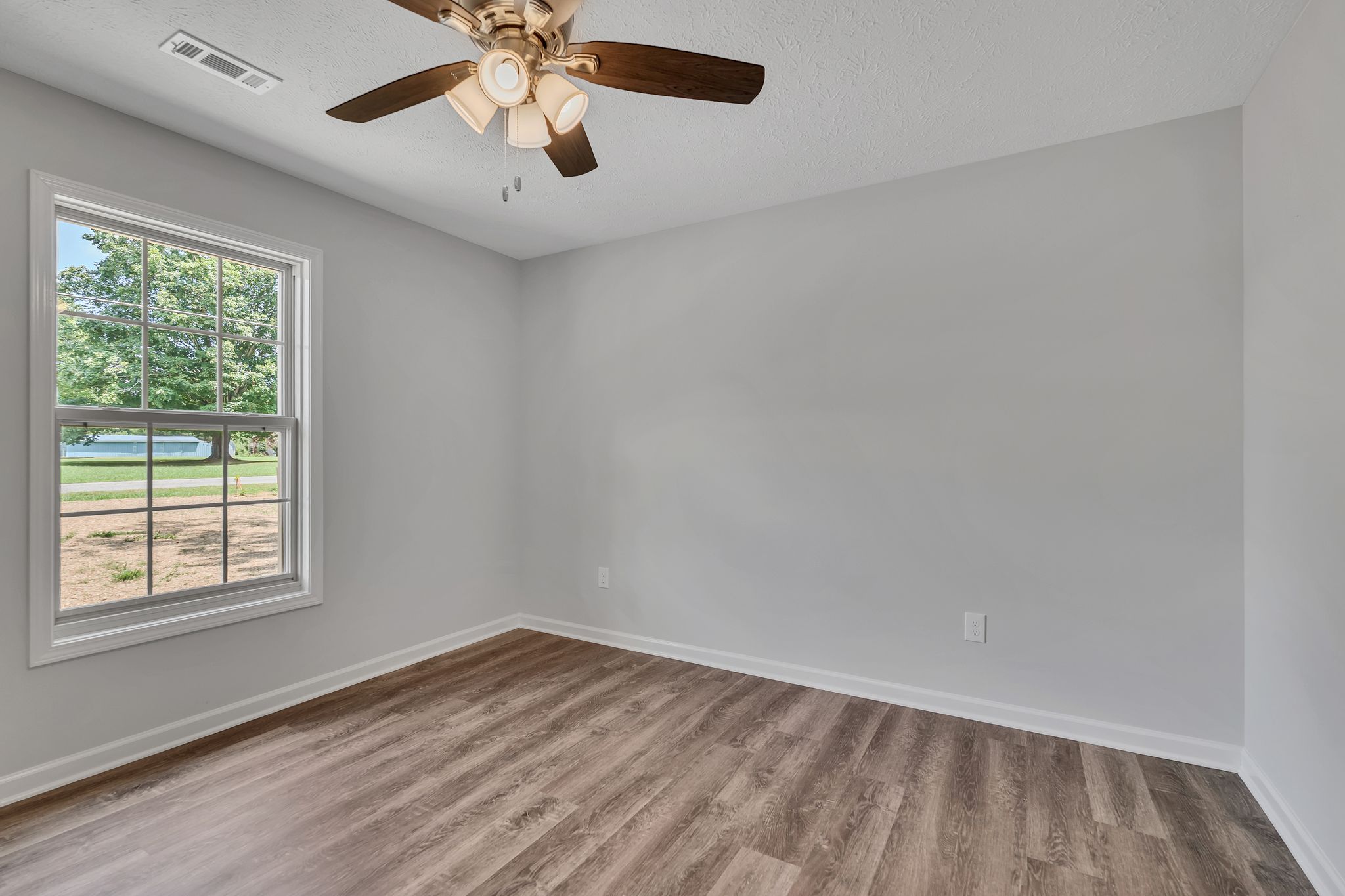 563 Paynes Church Road Estill Springs, TN 37330 - Photo 22 of 31 an empty room with a window and a ceiling fan