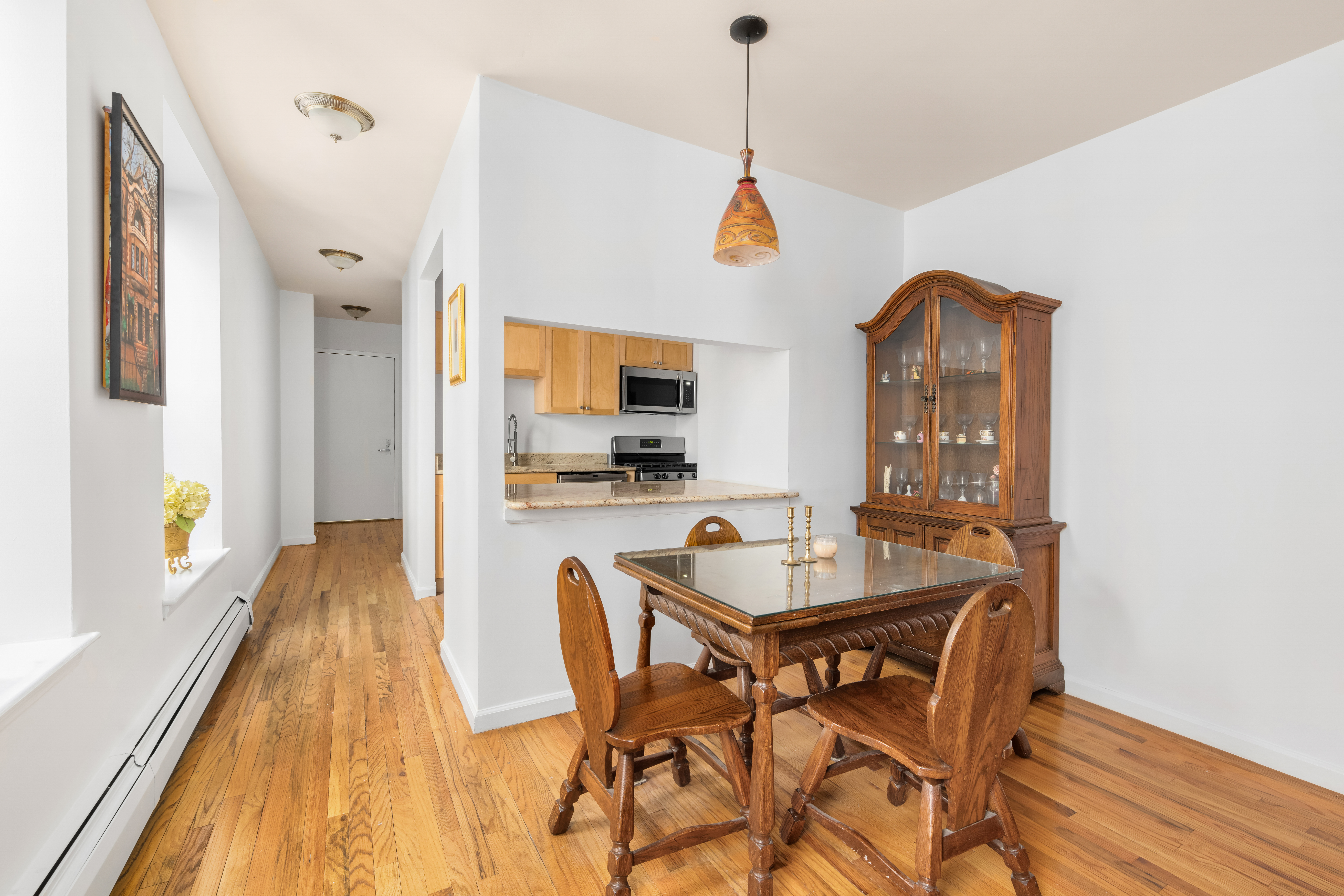 231 West 148th Street, Unit 2L Manhattan, NY 10039 - Photo 4 of 15 a view of a dining room with furniture window and wooden floor