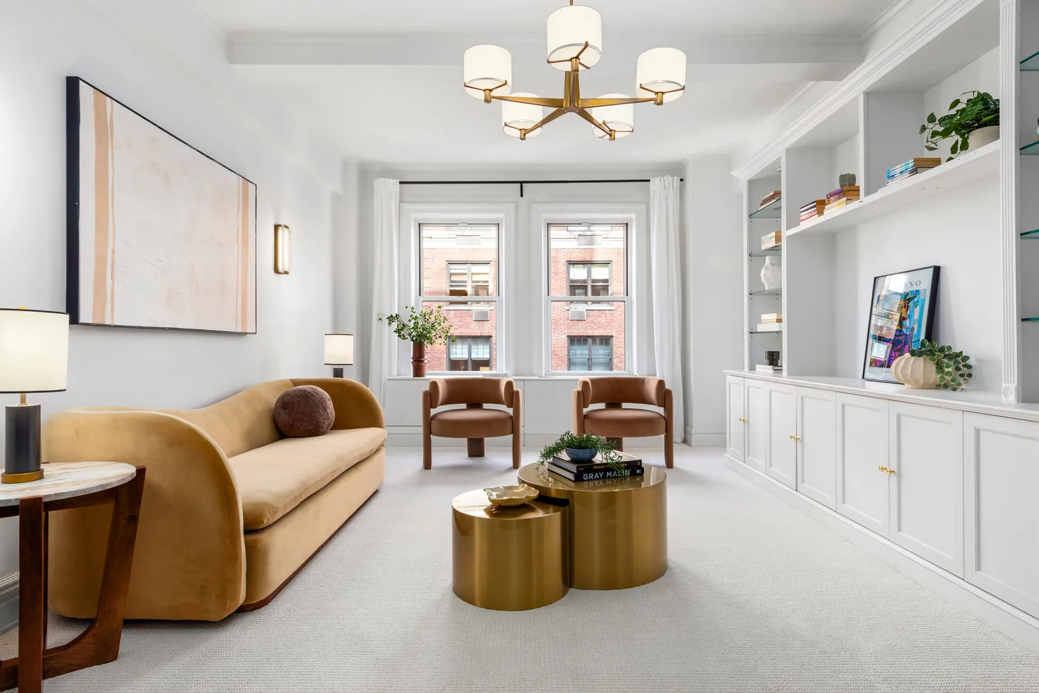 a living room with furniture a chandelier and a flat screen tv