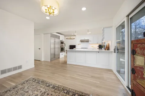 a view of a kitchen with a sink a refrigerator and window