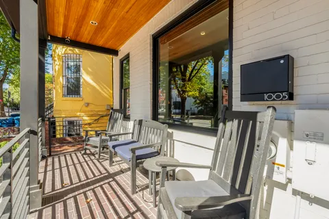 a view of a living room with a flat screen tv and floor to ceiling window
