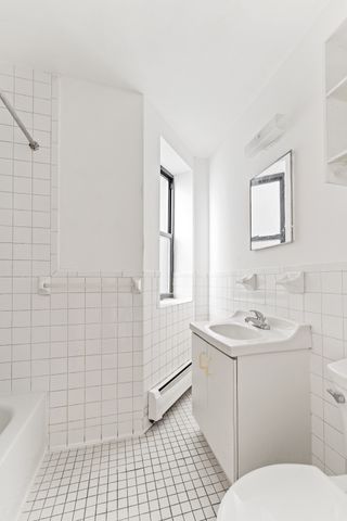 327 Pleasant Avenue, Unit 5B Manhattan, NY 10035 - Photo 3 of 5 a bathroom with a sink toilet and shower