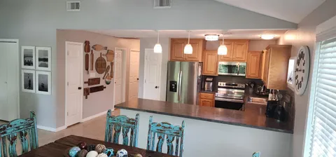 a kitchen with stainless steel appliances granite countertop a refrigerator and a stove