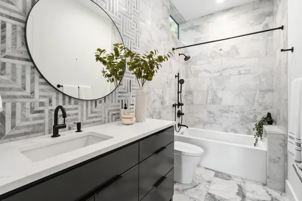a living room with furniture floor to ceiling window and wooden floor