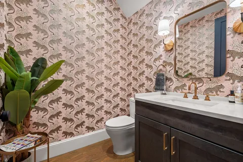 a bathroom with a sink a toilet and a mirror