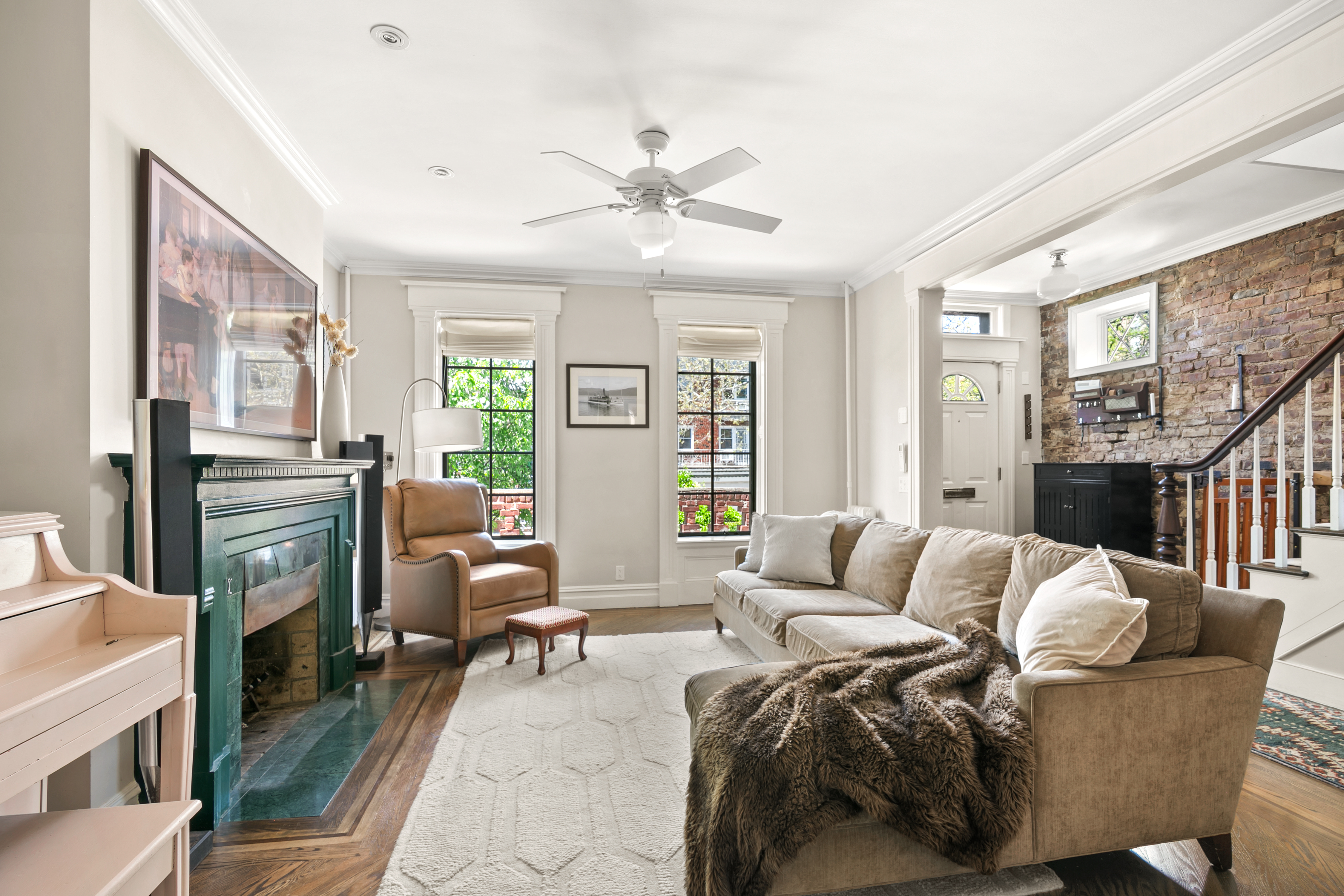 41-27 39th Place Queens, NY 11104 - Photo 1 of 13 a living room with furniture a fireplace and a large window
