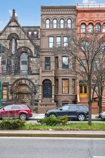 a front view of a house with a garden and parking