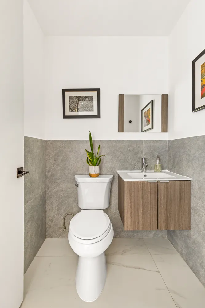 a bathroom with a granite countertop toilet a sink and bathtub