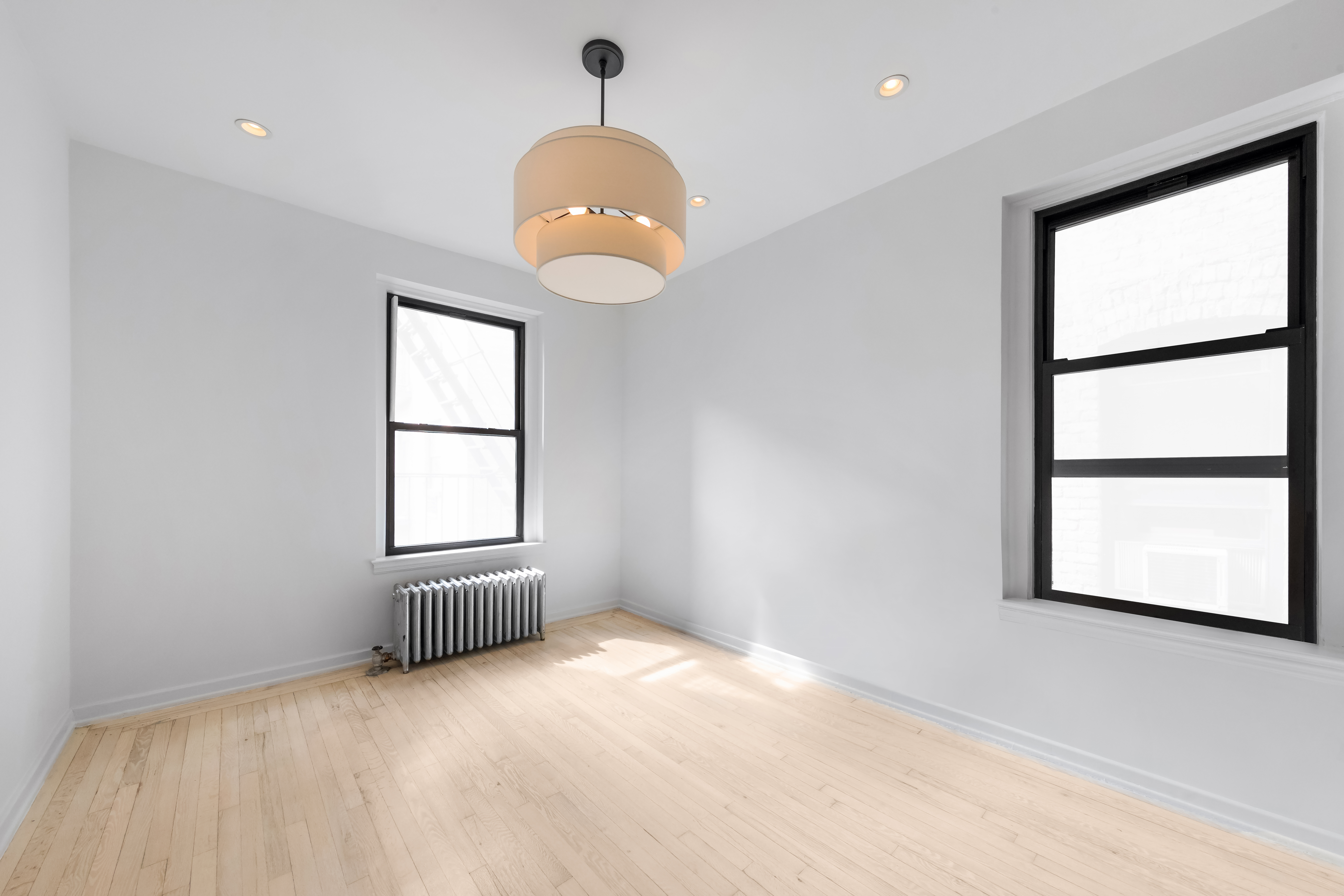212 East 13th Street, Unit 4D Manhattan, NY 10003 - Photo 2 of 8 an empty room with windows