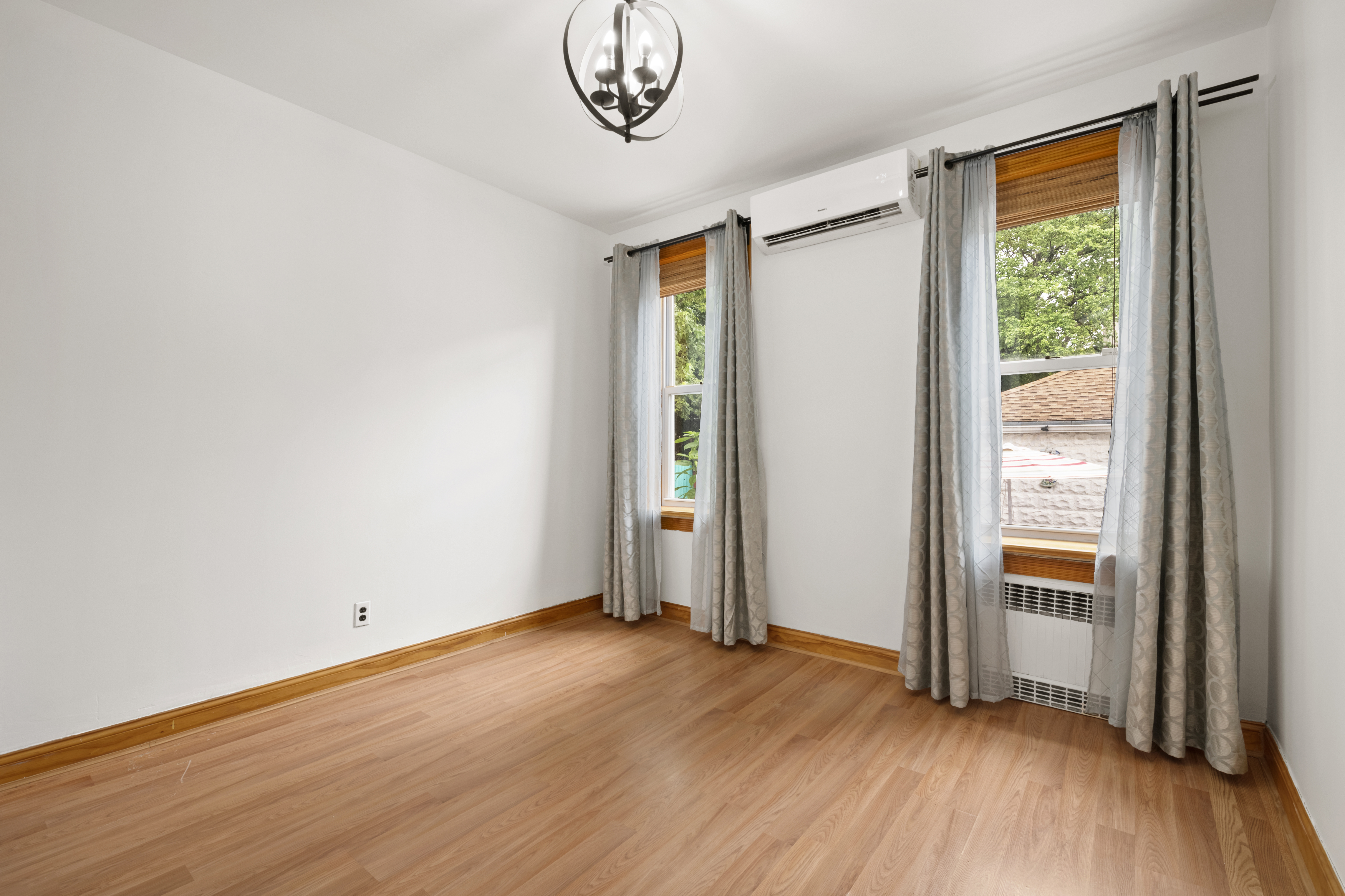95 Chester Avenue, Unit 1 Brooklyn, NY 11218 - Photo 7 of 13 a view of empty room with wooden floor and fan