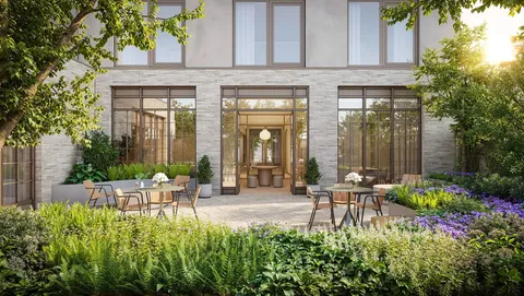 a view of a chair and tables in the patio in front of house