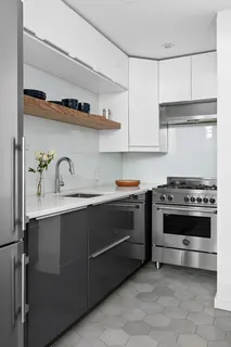 a kitchen with stainless steel appliances a stove and cabinets